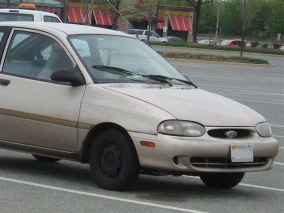 the front half of a cream gray ford aspire