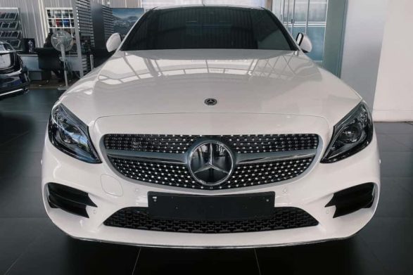 the front grille of a white 2021 mercedes-benz c-class