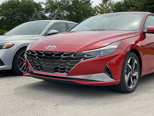 2022 Honda Civic Touring, blue, and 2021 Hyundai Elantra SEL, red 2022 Honda Civic Touring, blue, and 2021 Hyundai Elantra SEL, red