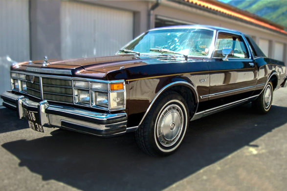 a dark maroon 1977 chrysler lebaron