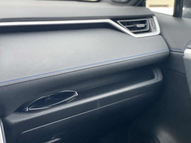 Clever storage spaces such as this dash shelf, as well as climate buttons and dials, give the 2023 Toyota RAV4 Hybrid some welcome practicality in the digital age.