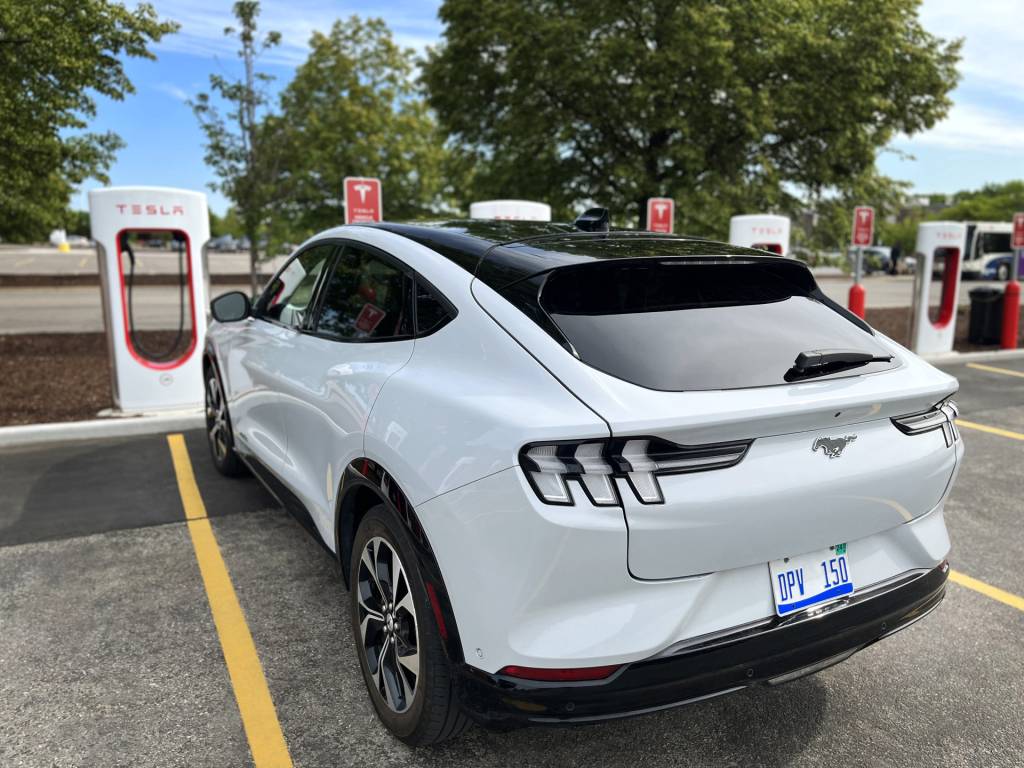 Ford Mustang Mach-E at Tesla Supercharger station