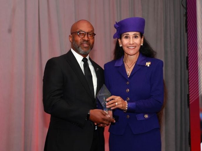 Perry Watson IV, president of the National Association of Minority Automobile Dealers, presents Rita Case, president and CEO of Rick Case Automotive Group, with the organization’s Lifetime...