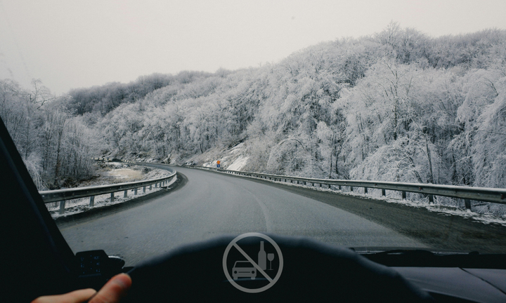 car driving down snowy road