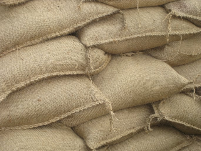 Closeup photo of a pile of jute sandbags